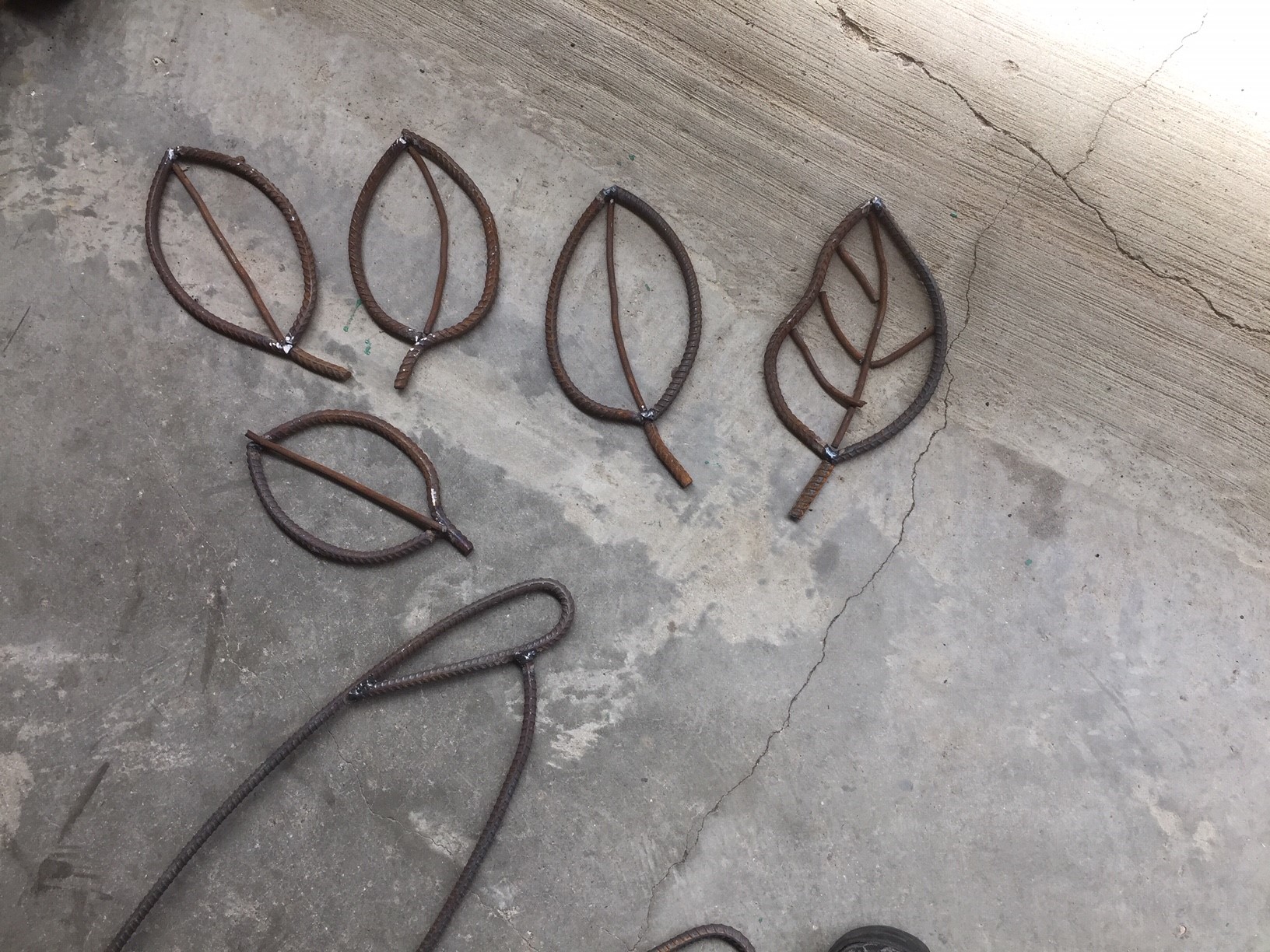 Five unique leaves sculpted out of metal.