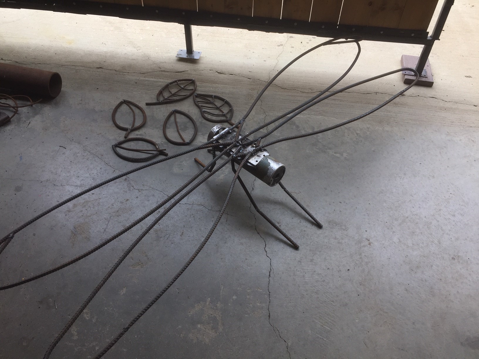 A dragonfly torso and wings sculpted out of metal